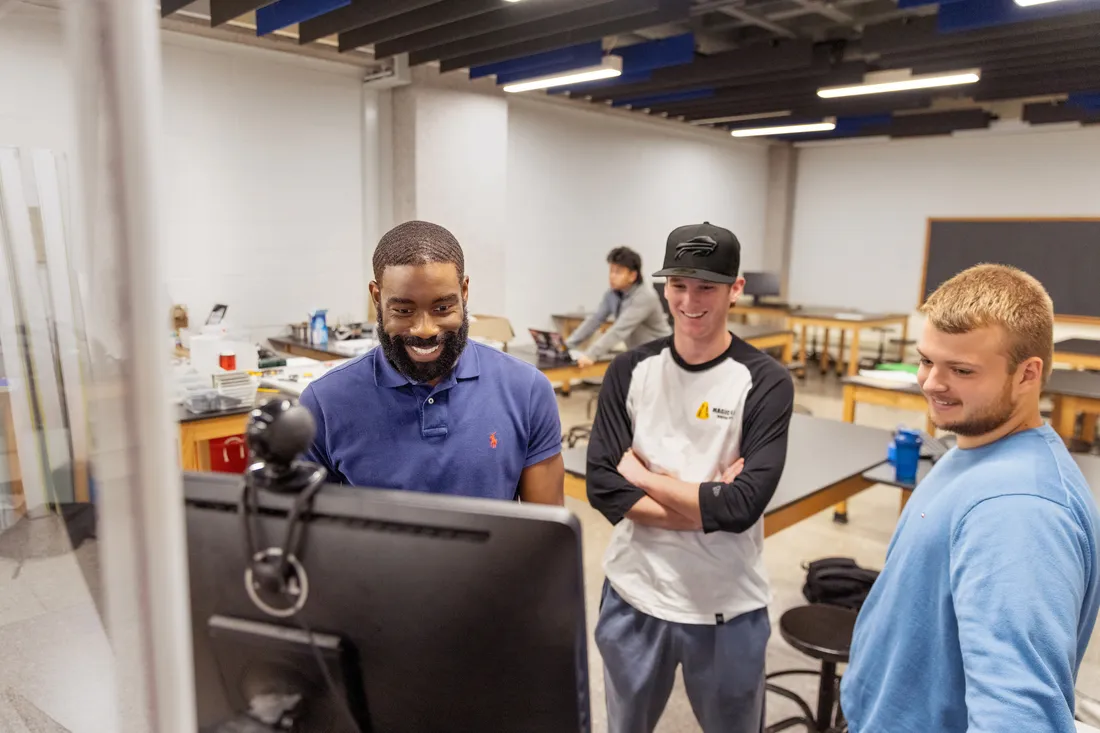 People looking at a computer.