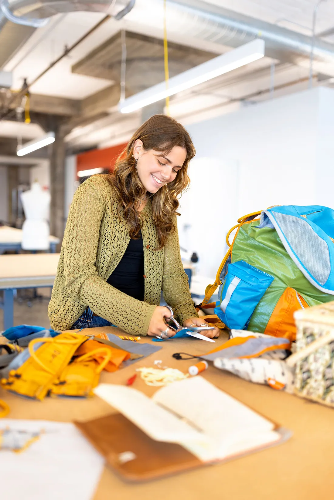 Student working on making her backpack.