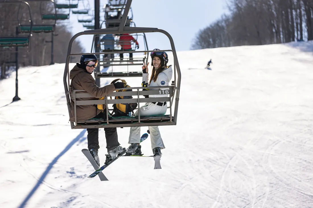 People on a ski lift at Song Mountain.