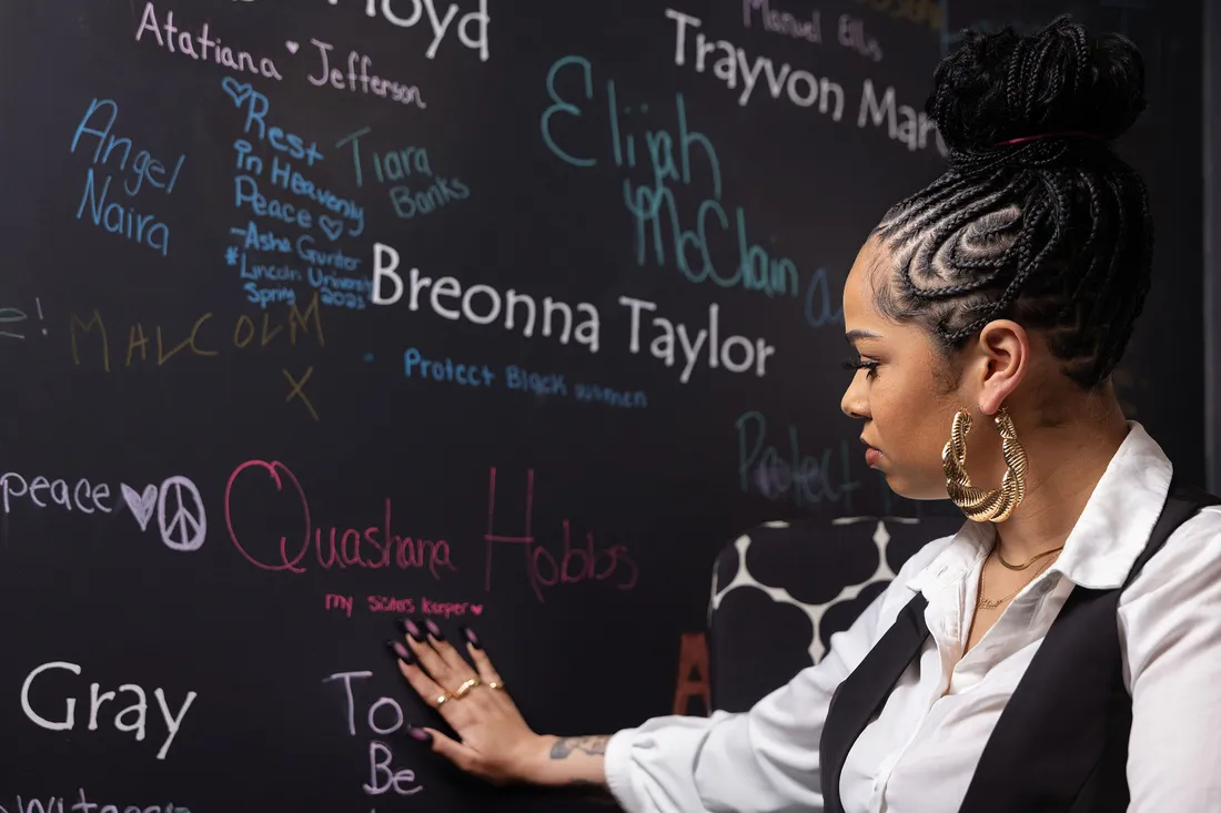 Darla Hobbs pointing to a chalk board.