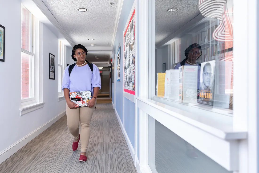 Biotechnology and African American Studies major, Jazmine Richardson, walks down the hallway of Sims Hall outside the Dr. Martin Luther King Jr. Memorial Library.