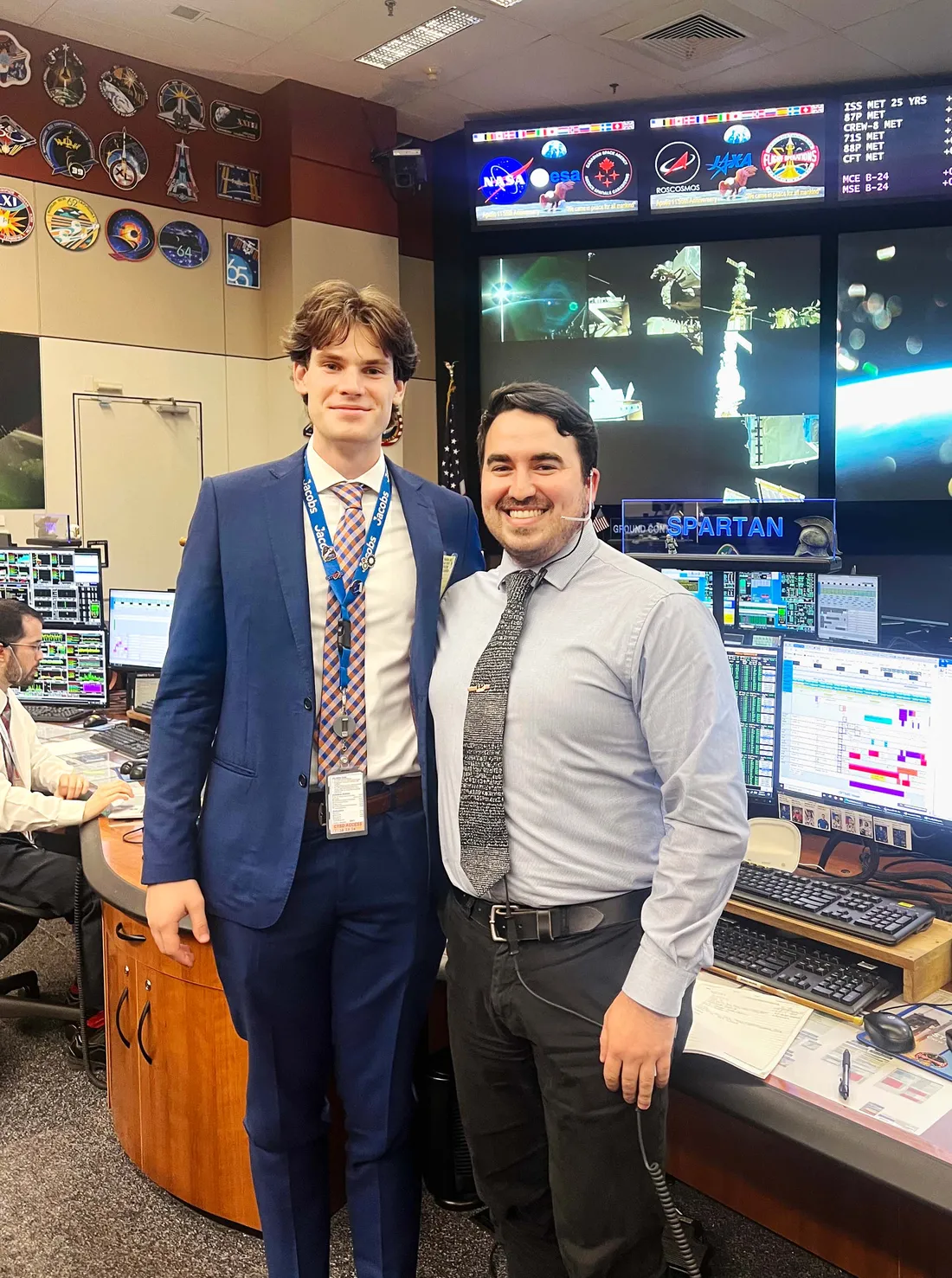 Brady Arruda with a coworker inside a control room.