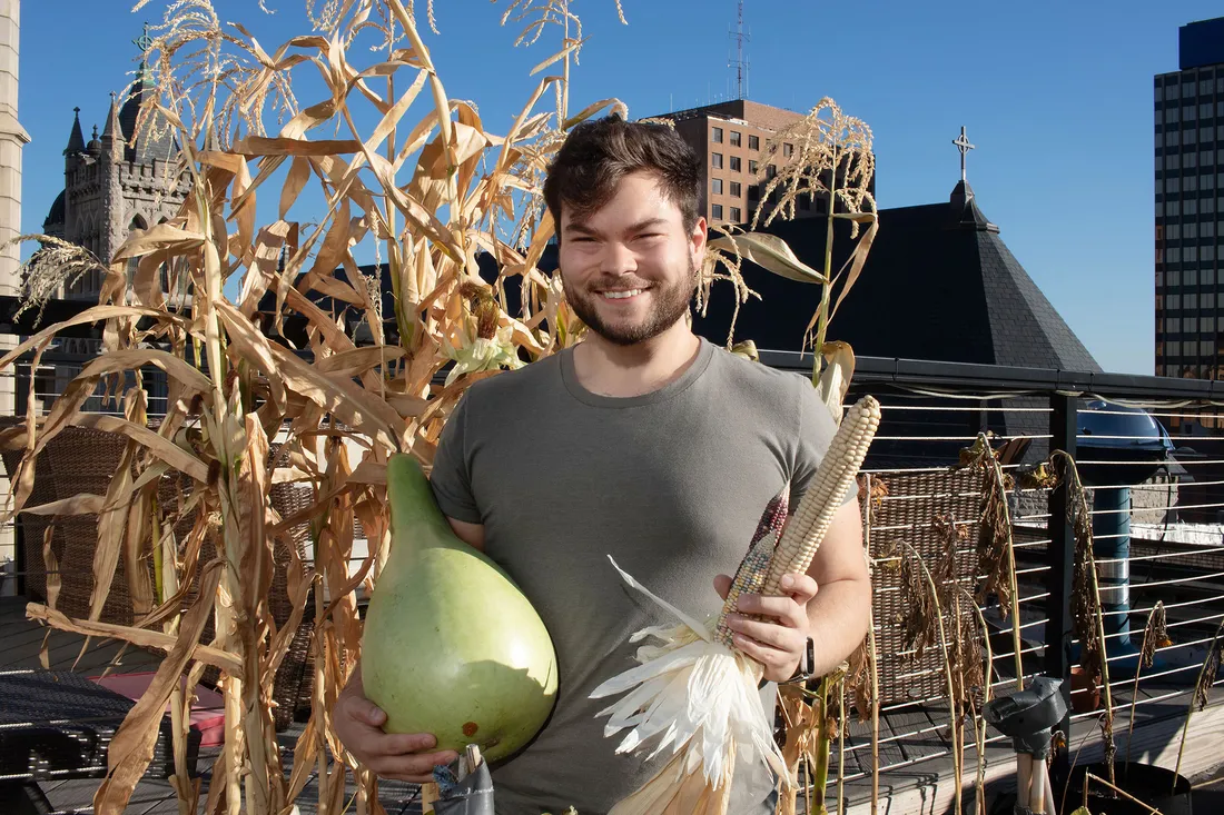 Portrait of Ethan Tyo, posed with fall harvest.