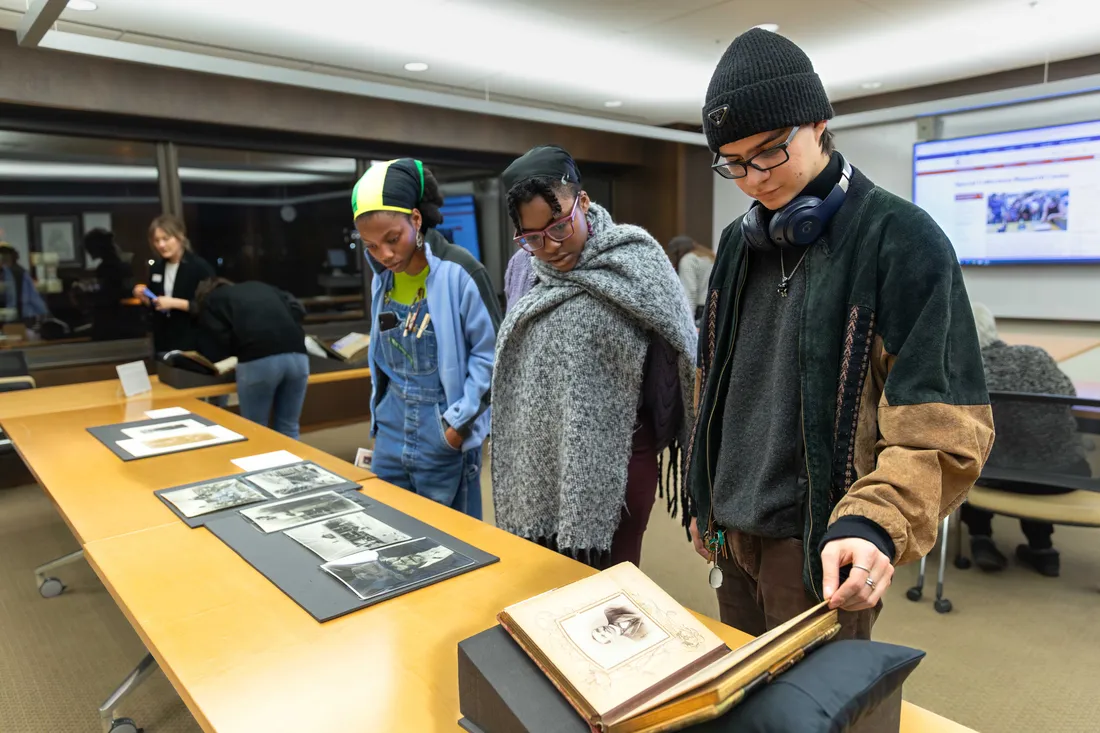 Students at the family pictures pop up exhibition at Bird Library.