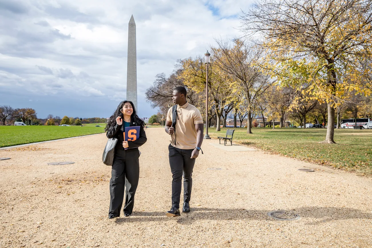 Two people walking the Washington Monument.