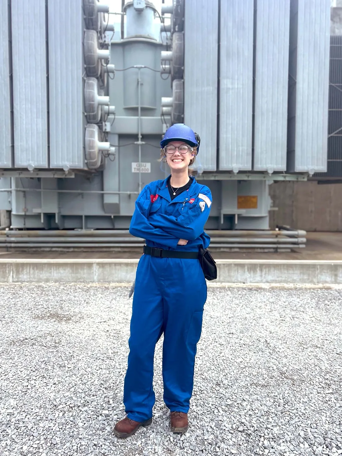 Ellie Parks standing in front of an electric transformer.