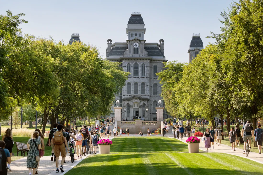 Students walking on campus in front of the Hall of Languages.