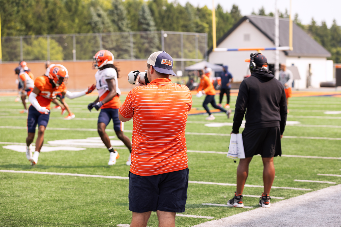 Kevin McGurn shooting photos on the sidelines.