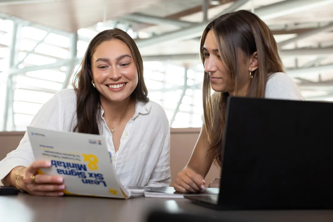 Business student sitting and smiling.