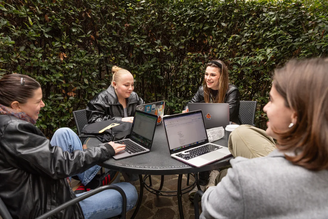 Four people sitting around a table.