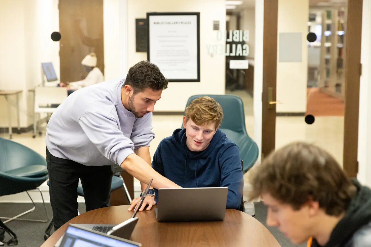 Students looking at a computer.