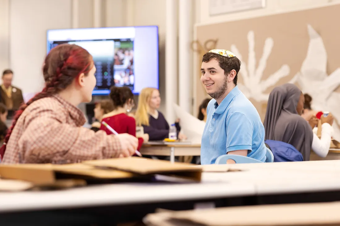 Avi Berzofsky talking to a student.