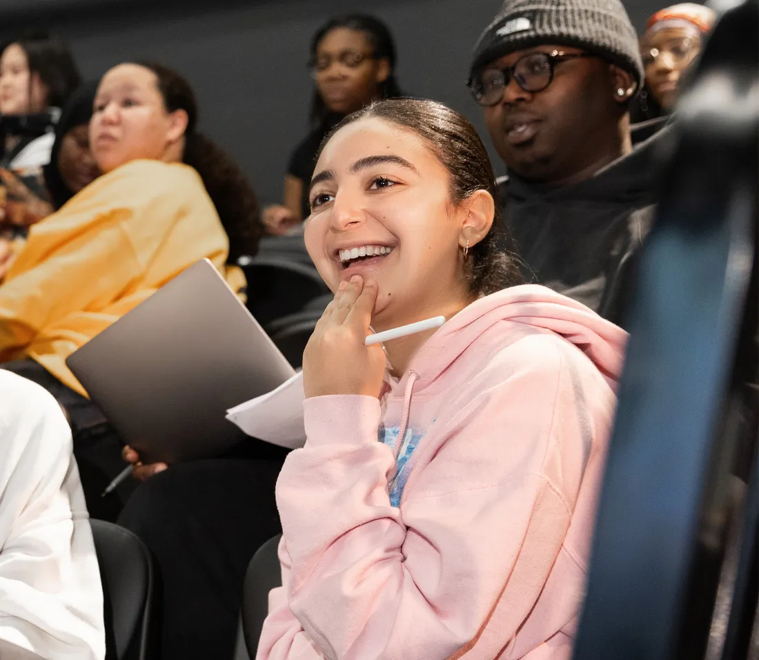 Tanisha Jackson sitting in class smiling.