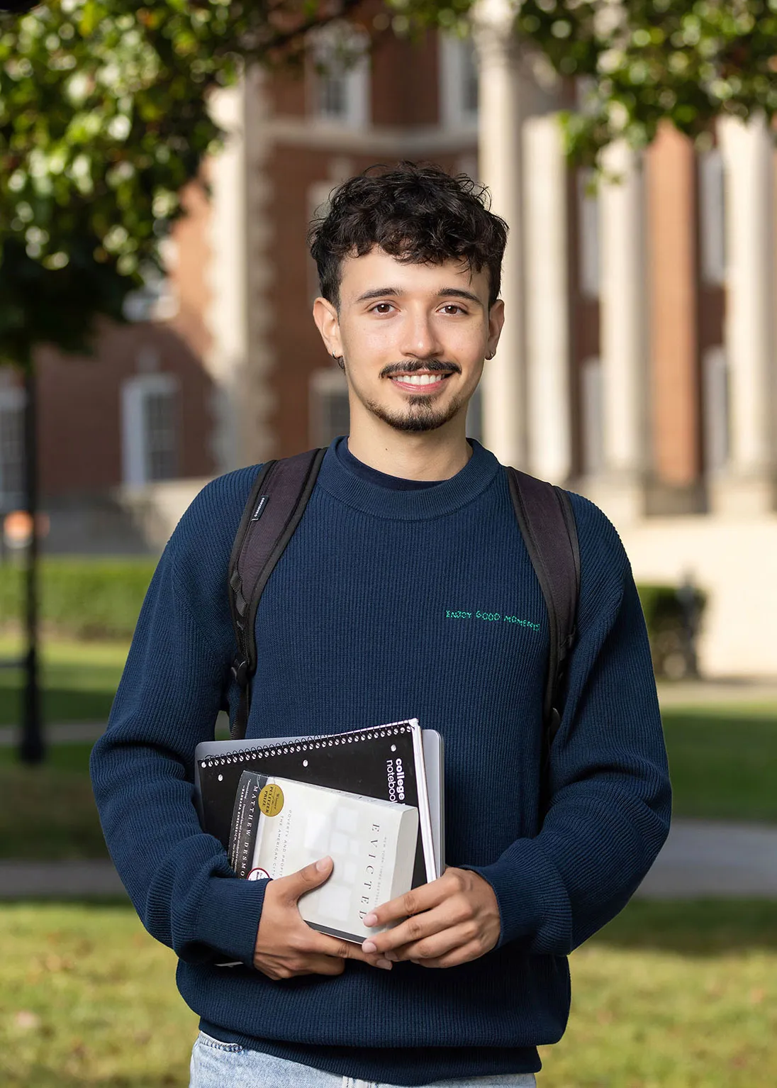 Jacob Grindoff Espinal standing and smiling.