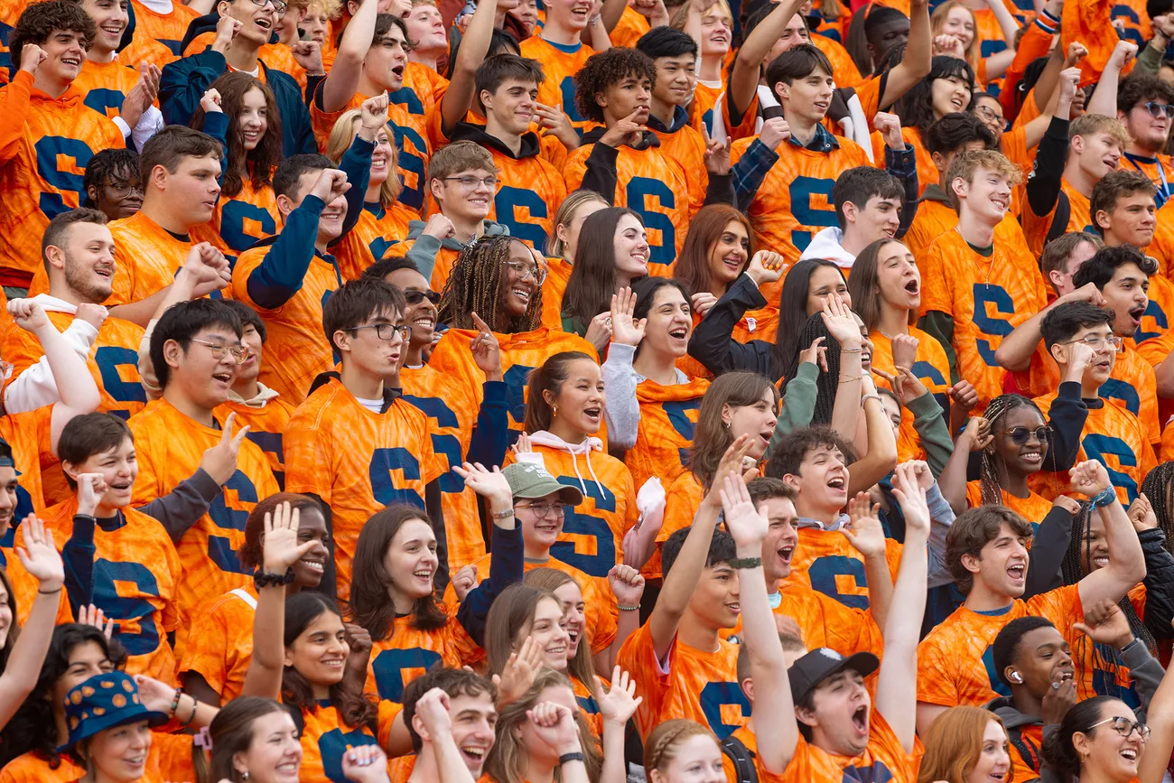 Students in a crowd cheering.