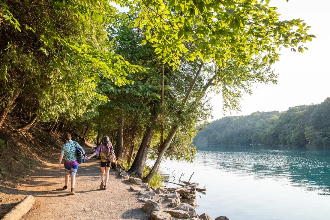 Two people walking at Green Lakes State Park.