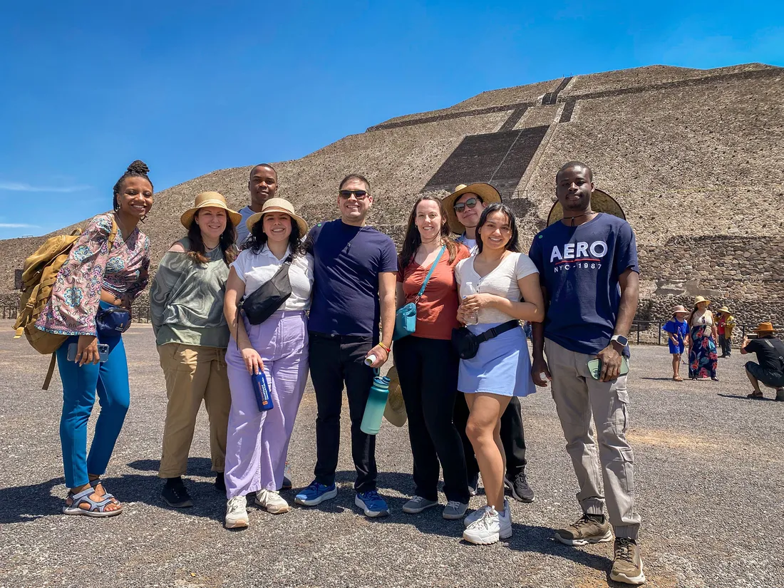 People standing outside a historical monument in Mexico.