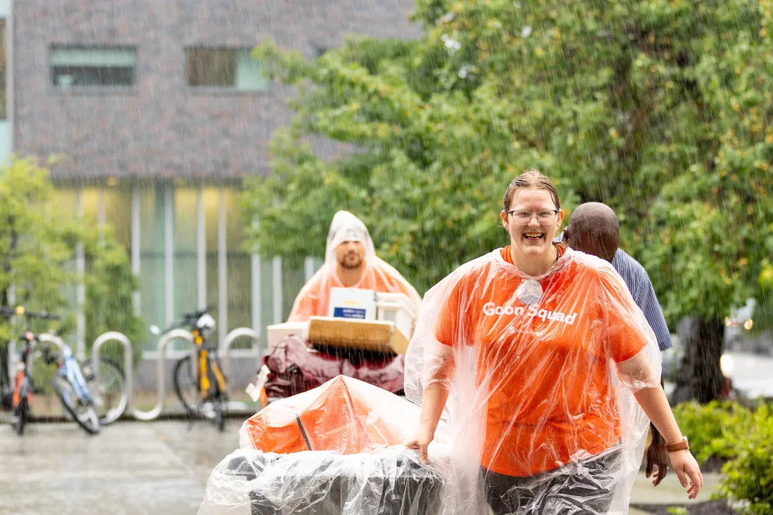 Two people pulling a cart.