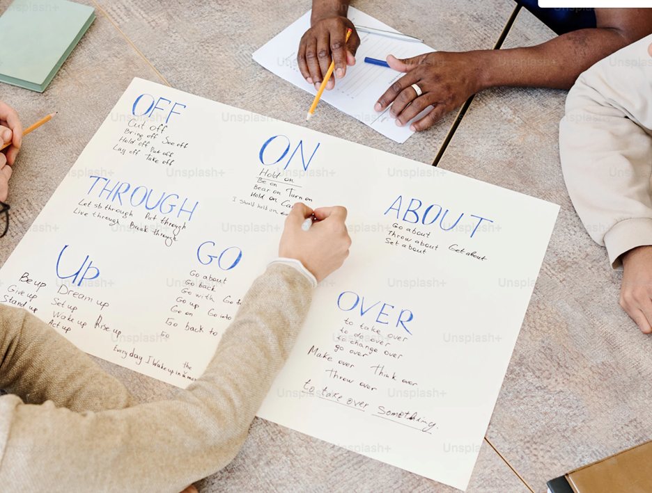 People writing on a piece of paper.