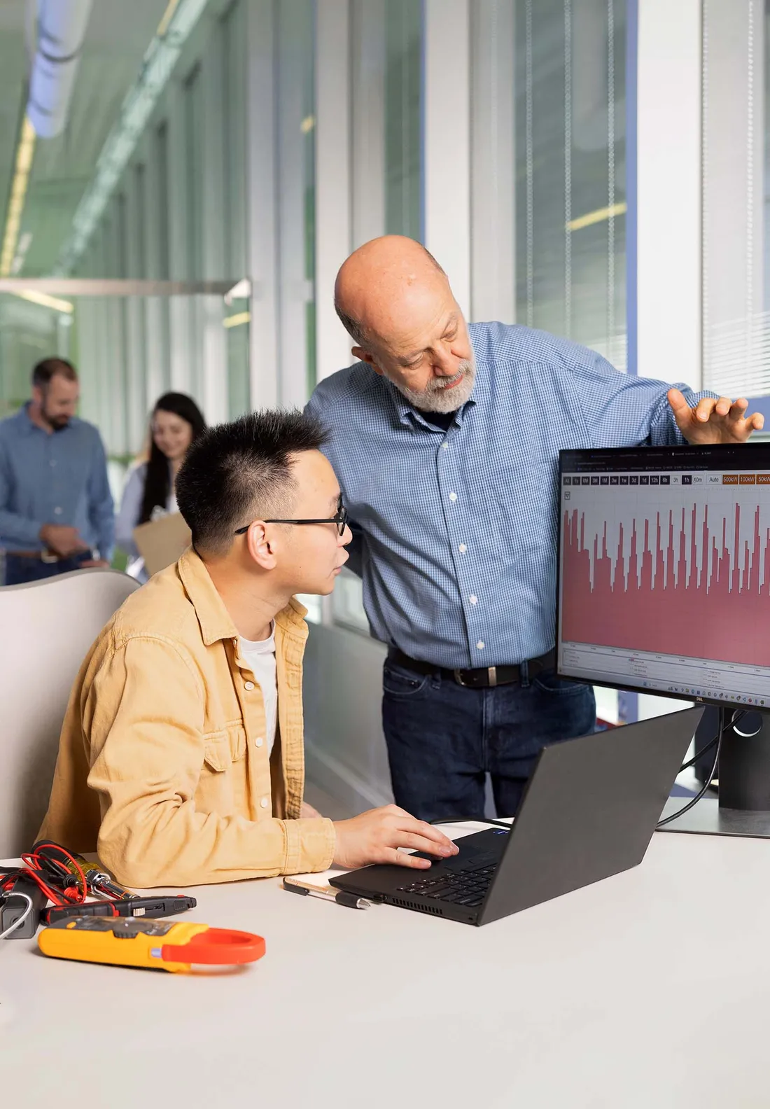 Ian Shapiro working with a student at a computer.