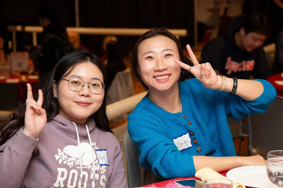 Students smiling at the International student thanksgiving dinner.