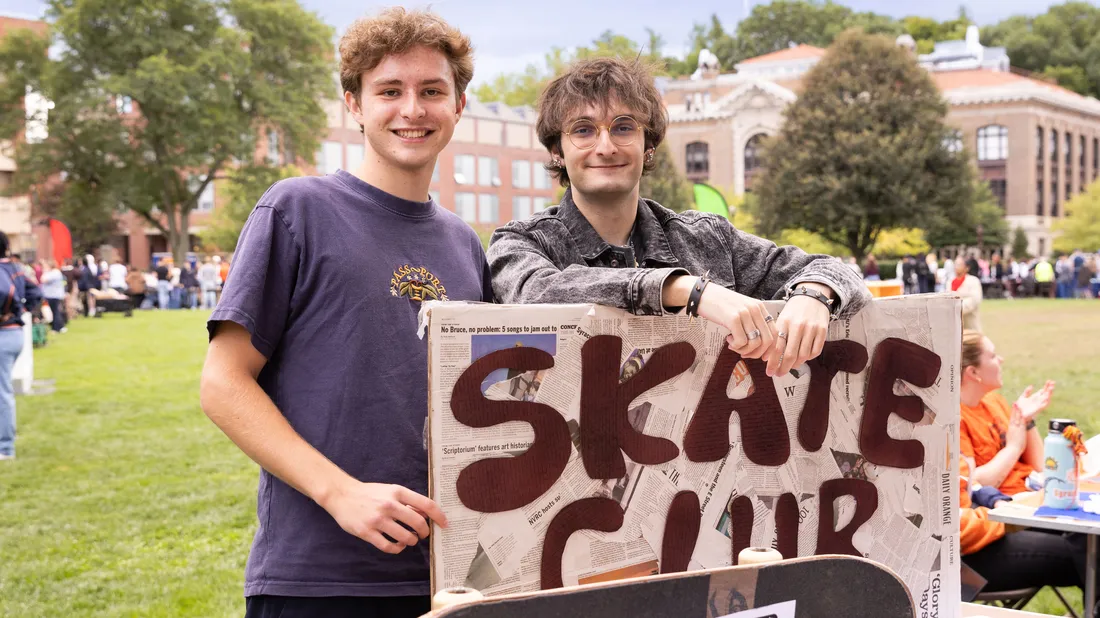 Two students promoting Skate Club at the Involvement Fair.