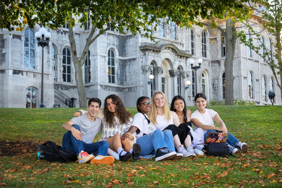 Students under a tree on Syracuse University's campus.