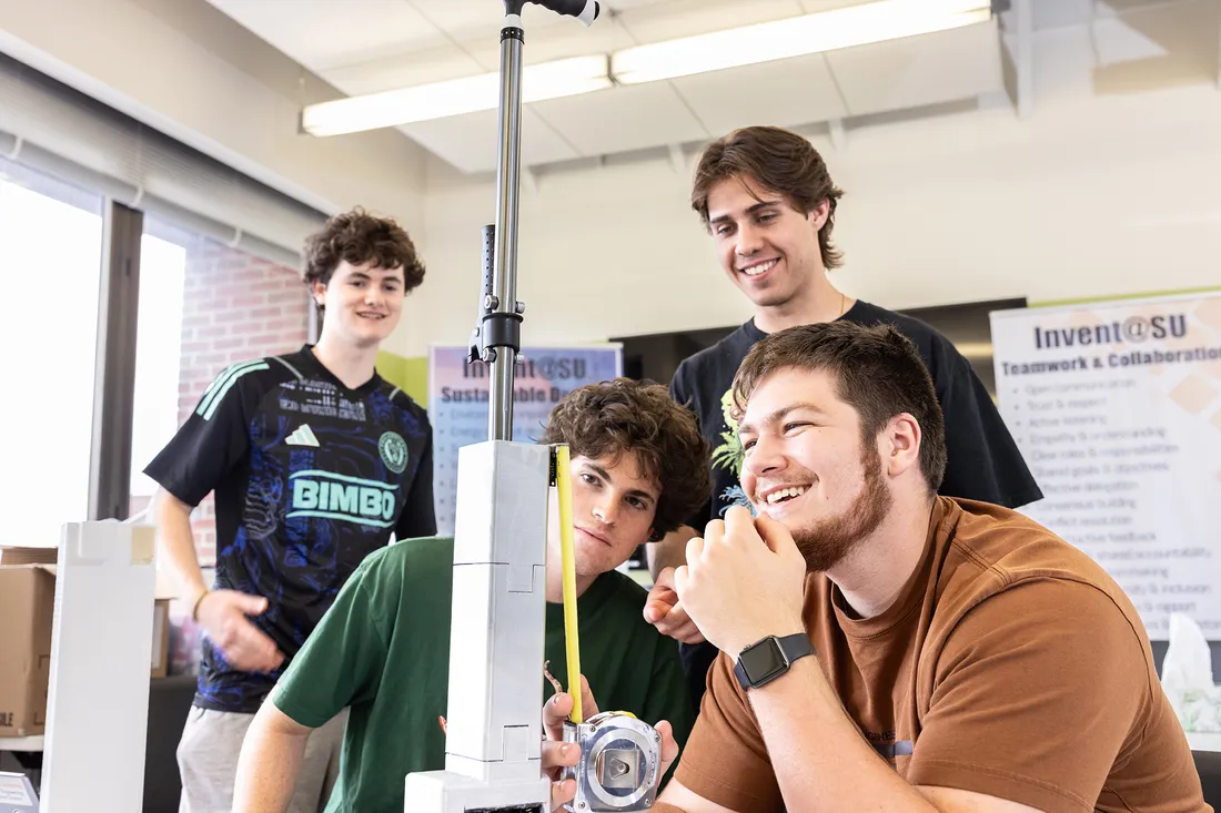 Four students examine invention.