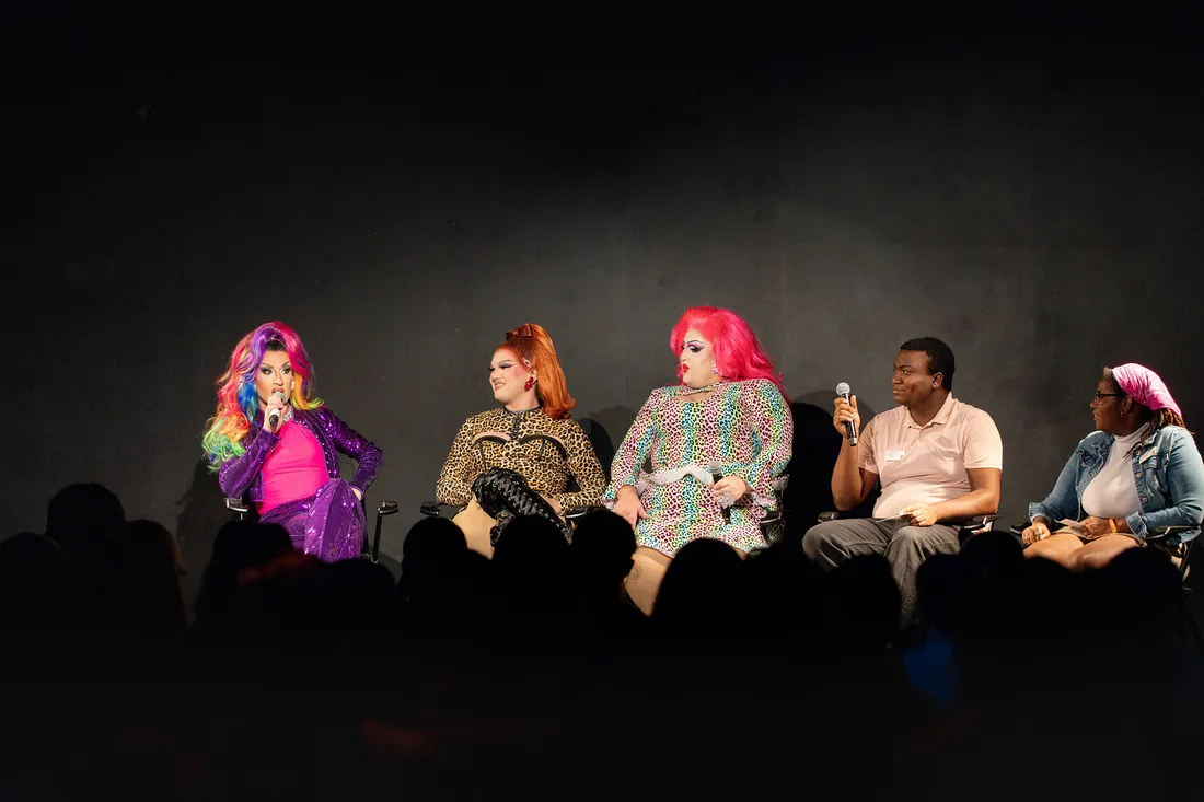 People sitting at the LGBTQ history month kickoff.