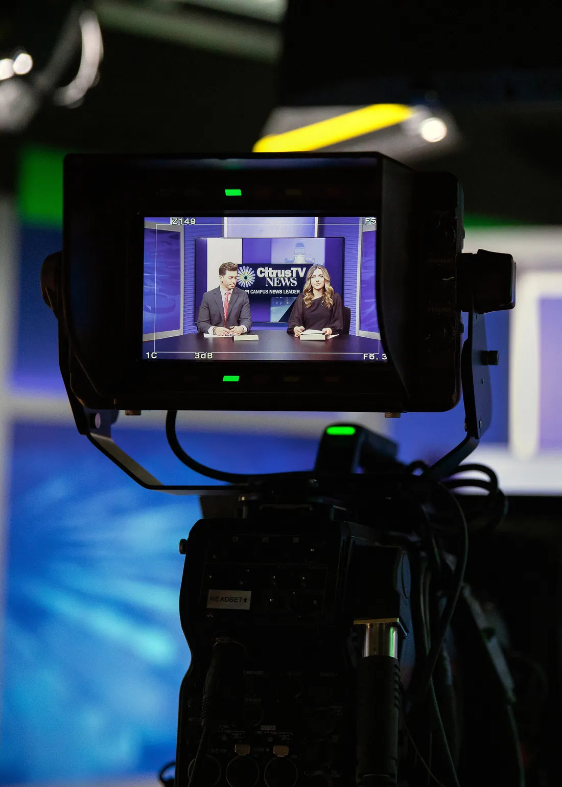 Students sitting behind a camera.