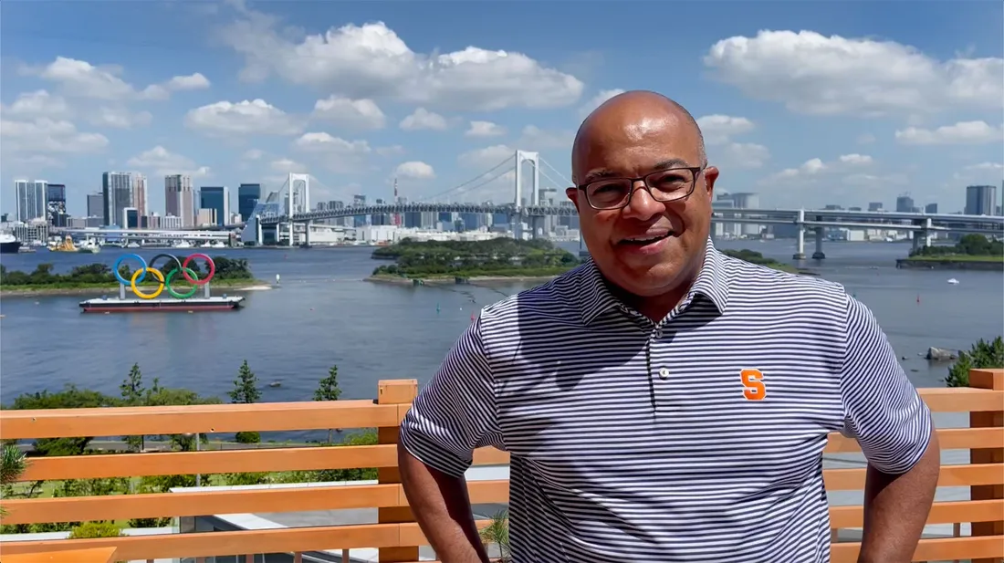 Mike Tirico ’88  standing by the water at 2021 Tokyo Olympics.