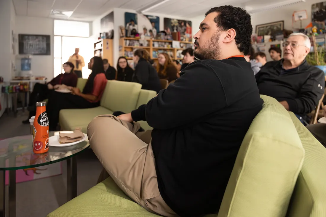 People sitting watching a movie.