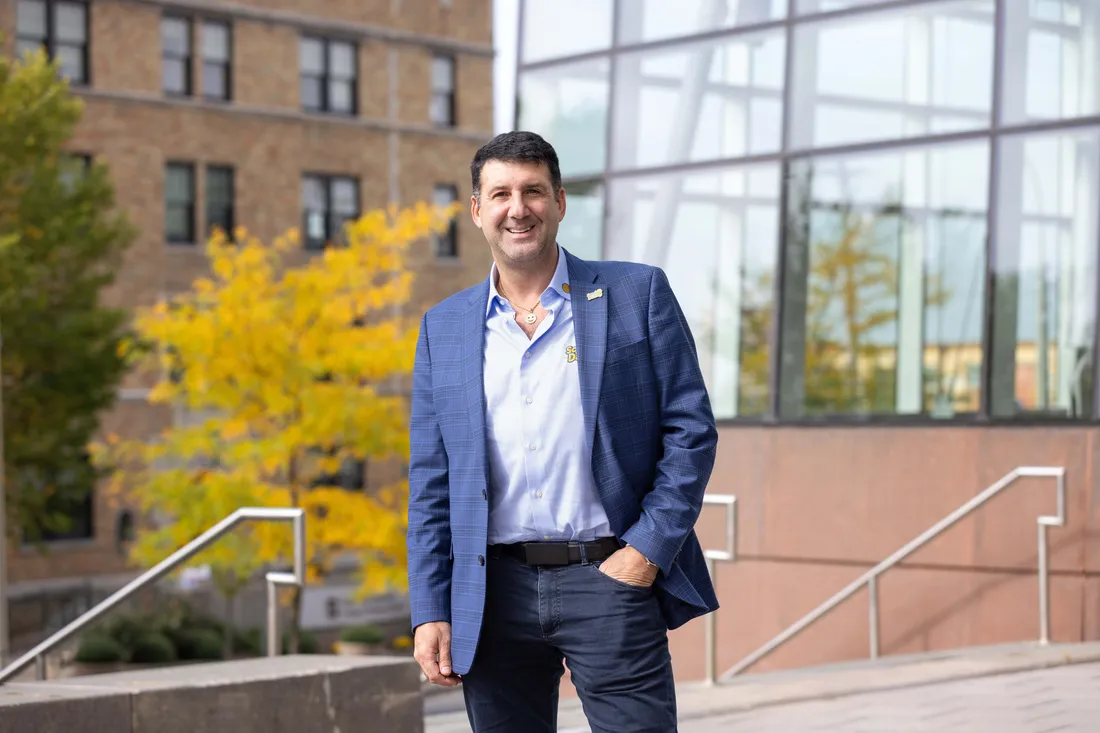 Alumni Aaron Krause the founder of Scrub Daddy standing and smiling outside Whitman School of Management.