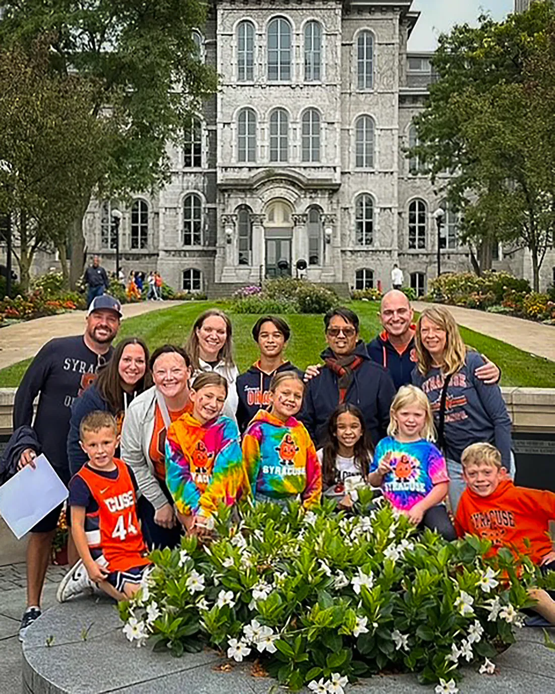 Alumni and their families taking a picture in front of the hall of languages.