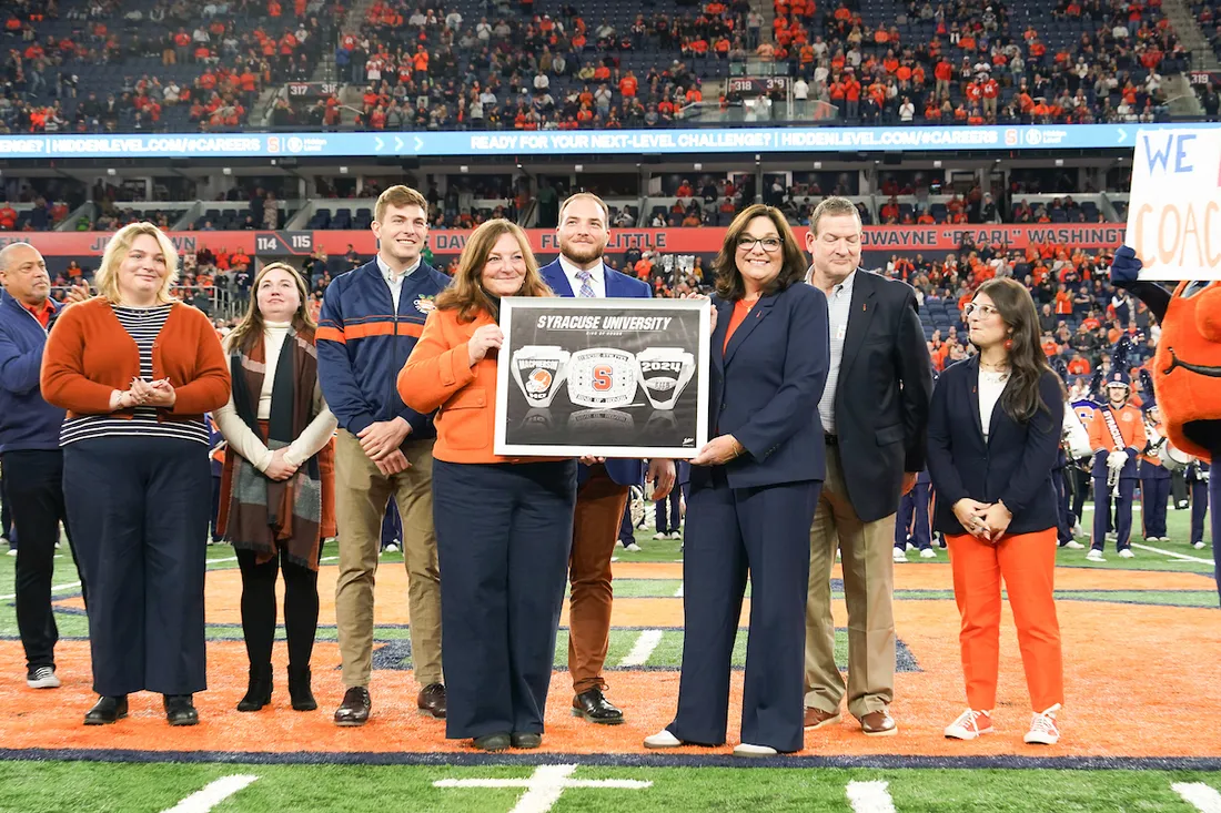 The family of Richard MacPherson accepting an award.