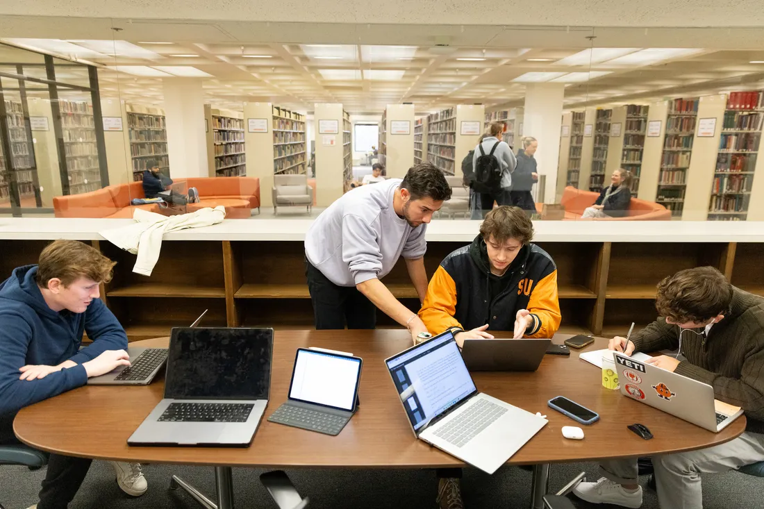 People working together in a group classroom at the library.