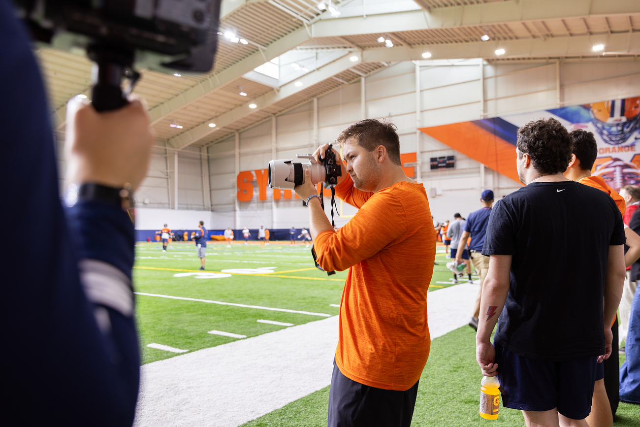 Kevin McGurn taking photos on the sidelines.