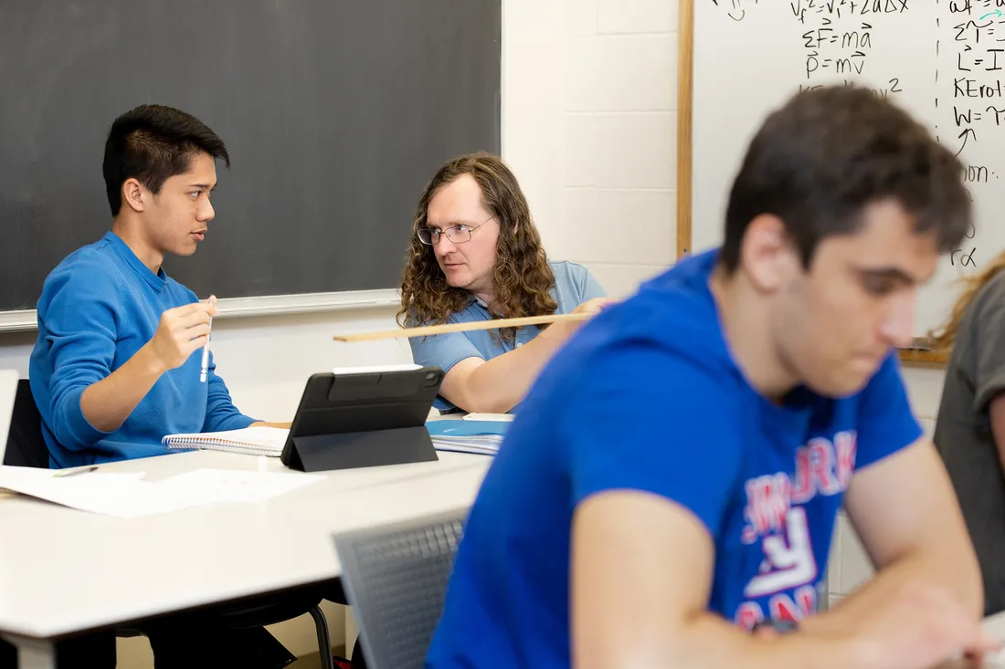 Walter Freeman working with a student in the Physics Lounge.