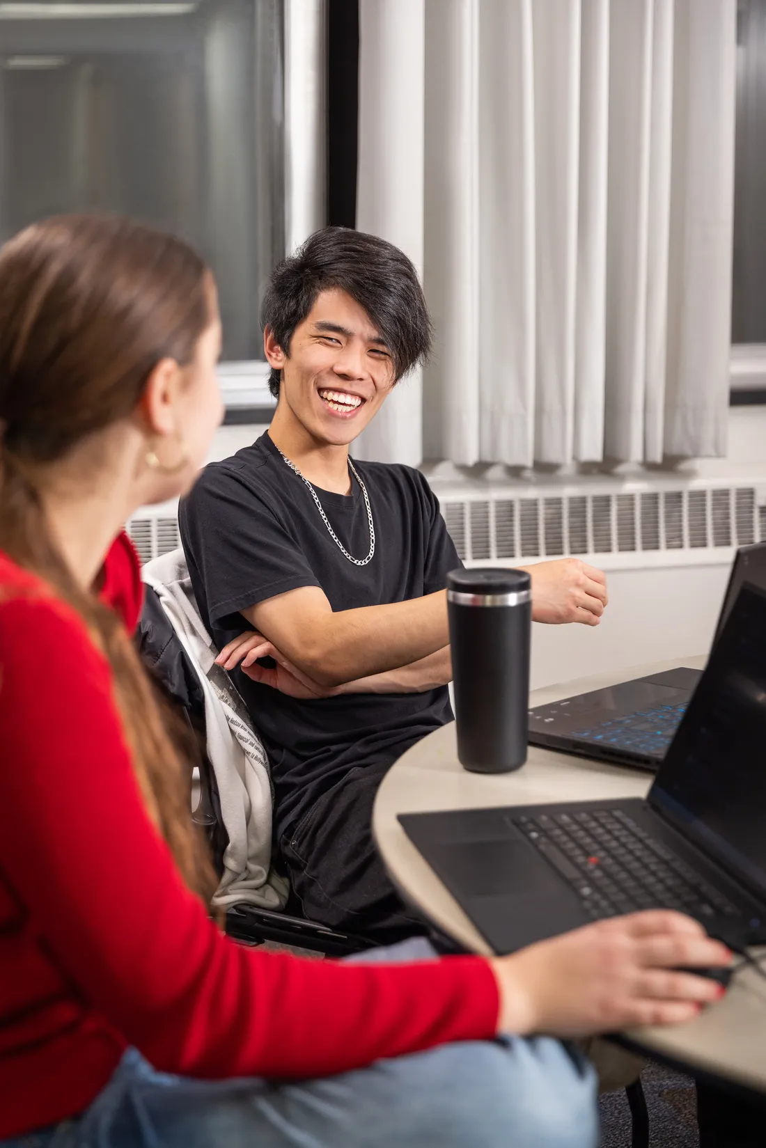 Issac Chin smiling at a student.