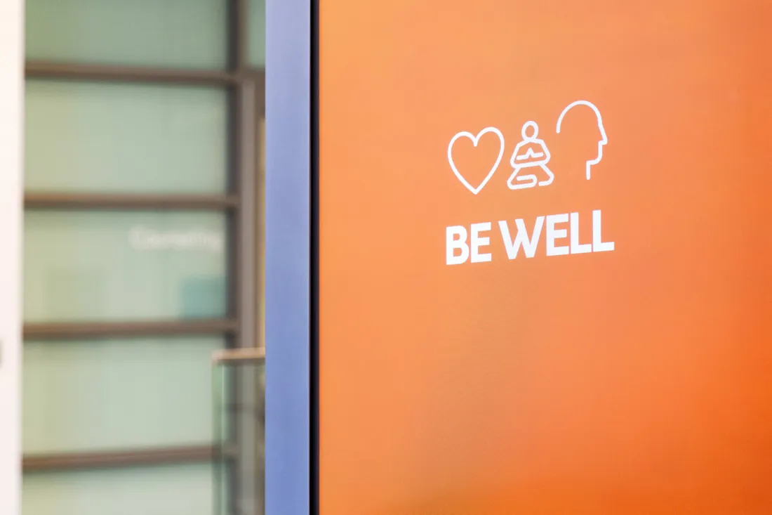 A door that says Be Well in the Barnes Center at The Arch.