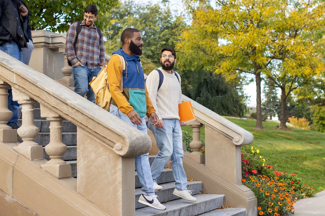 Jurgen Baeza Bernal walking with students on campus.