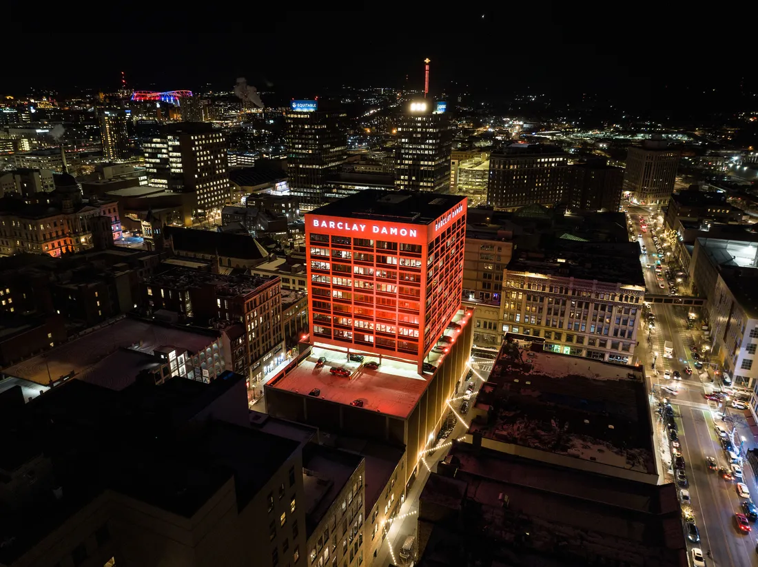 A drone image of the city of Syracuse at night.