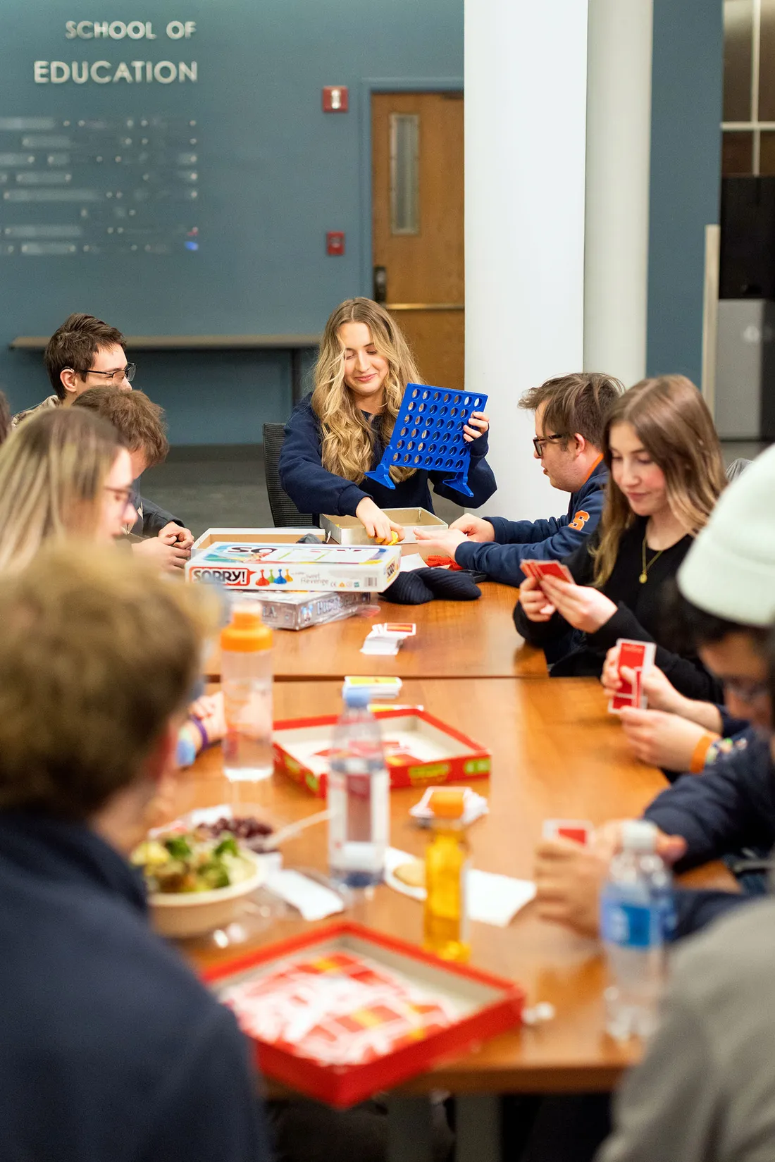 Students playing connect 4 at a table.