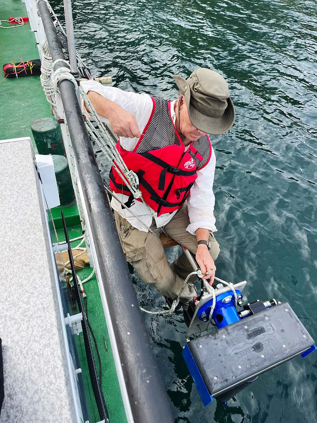 Chris Scholz pulling a research sample from a lake.