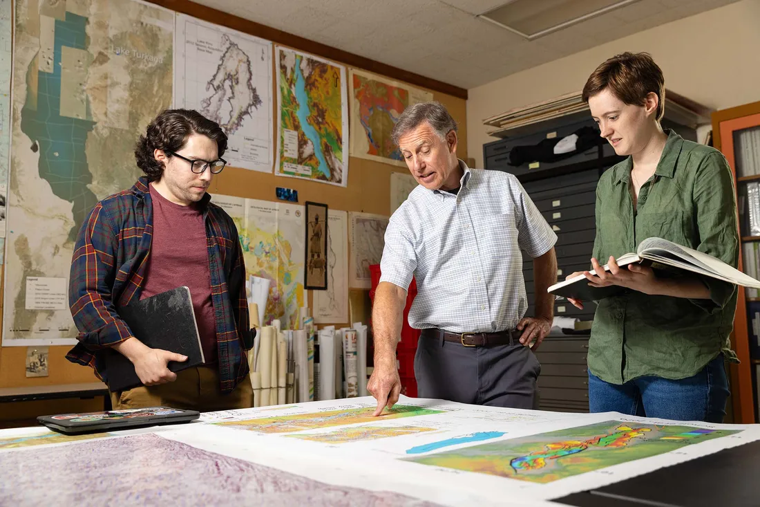 People around a table looking at a map.