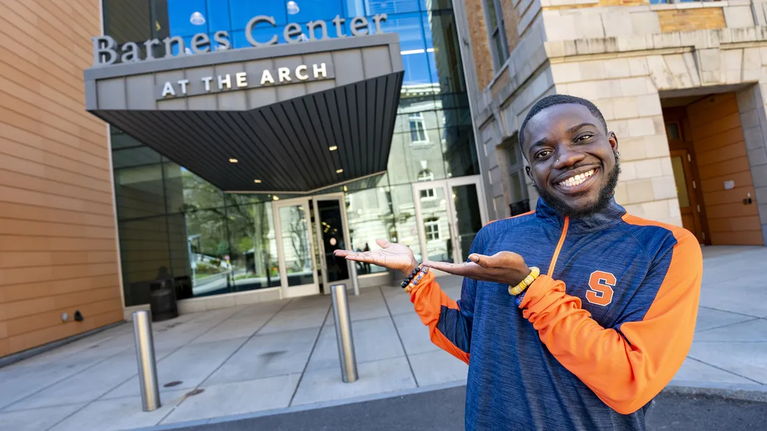 Kelvin Boakye '24 standing outside the Barnes Center at The Arch smiling.