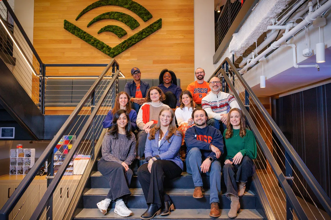 Group of people sitting on the steps at the Audible office.