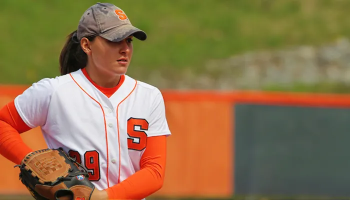 Jenna Caira in Syracuse uniform wearing a softball mitt.
