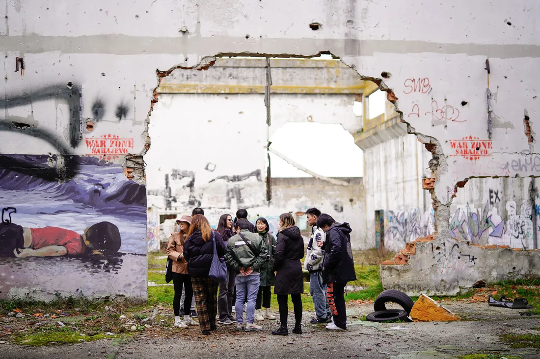 People outside ruins.