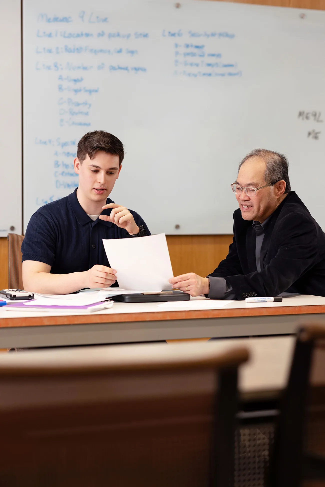 Student Benjamin Johnson working with a professor.